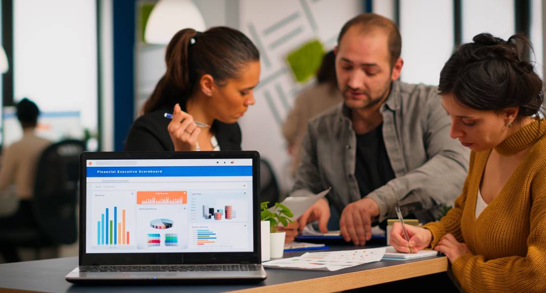 people working on a laptop in an office